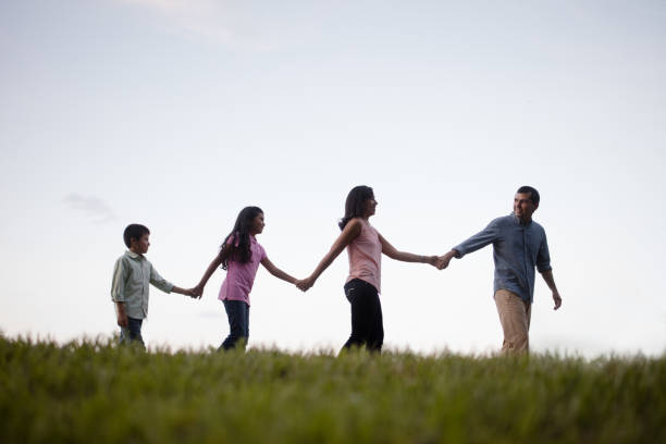 istock Happy family walking outdoors and holding hands 811220410