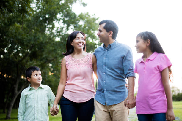 istock Happy latin family walking outdoors hand in hand 811220472