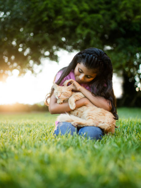 istock Latin holding and caressing cat outdoors 811224114