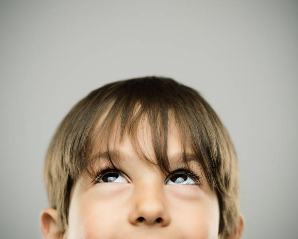 Smiling little boy looking up stock photo