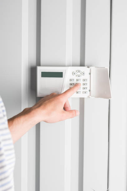 istock person typing password on home security alarm, security system concept 811227386
