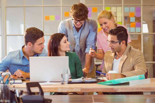 istock Happy creative business team using laptop in meeting 811233234