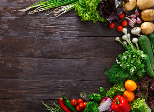 istock Frame of fresh vegetables on wooden background with copy space 811243288