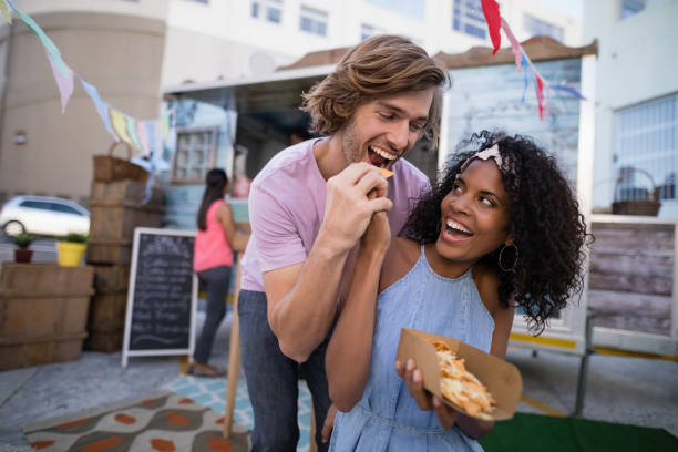 istock Happy woman feeding snacks to man 811243586