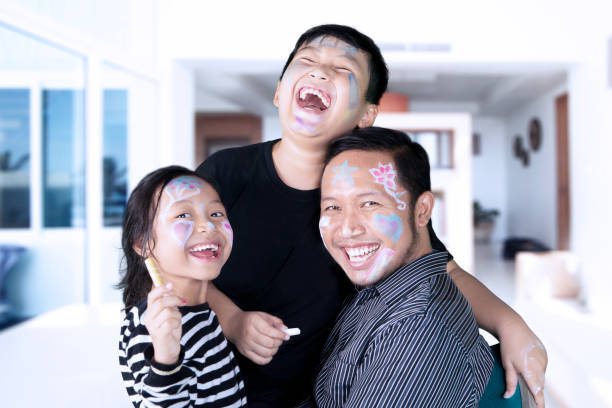 istock Funny family with crayons at home 811256630