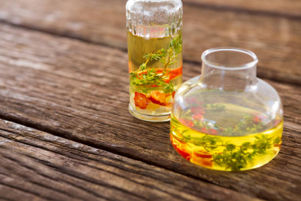 istock Olive oil with rosemary and red chili pepper in container 811259230