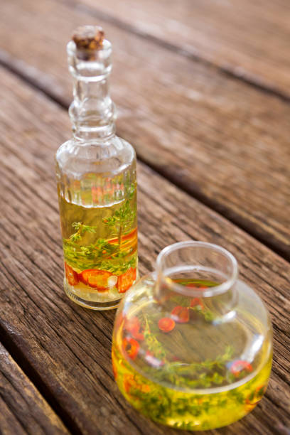 istock Olive oil with rosemary and red chili pepper in container 811259352
