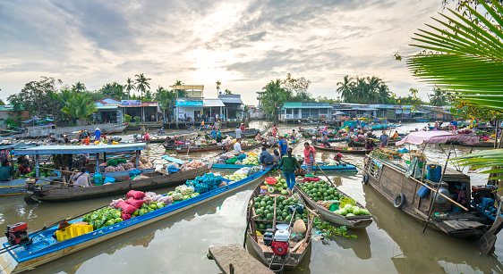 Can Tho, Vietnam - January 22, 2017: Farmers purchase crowded in floating market morning with dozens boats along river trade agricultural products serves traditional New Year in Can Tho, Vietnam