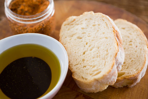 istock Olive oil with bread and spice powder on table 811264314