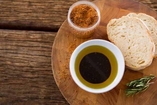 istock Olive oil with bread and spice powder on table 811264720