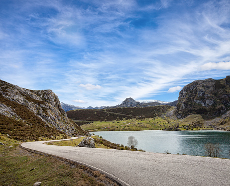 A road with a beautiful view near Lake Enol at sunny day , Picos de Europa Western Massif, Cantabrian Mountains, Asturias, Spain.