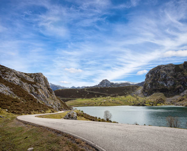 a road with a beautiful view near lake enol at sunny day , picos de europa western massif, cantabrian mountains, asturias, spain. - international landmark sunny lake sky imagens e fotografias de stock