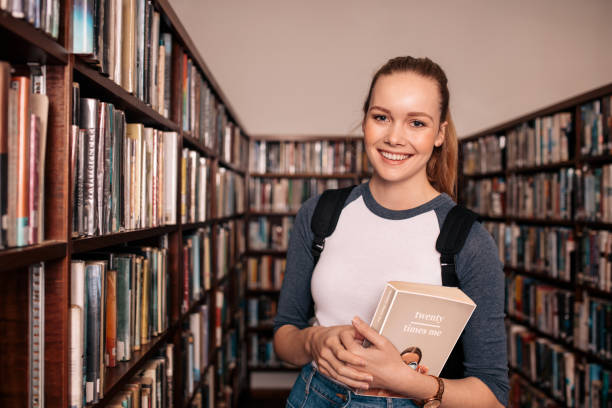 istock Young female college student in library 811276734