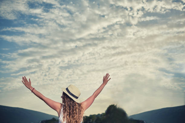 istock Young girl raising hands 811277514