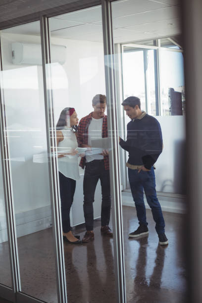 istock Business colleagues dicussing at office 811280144