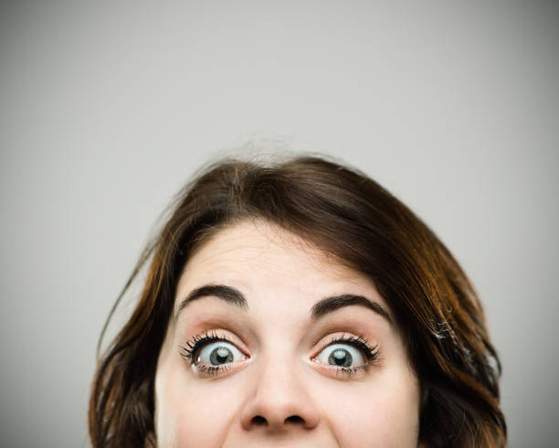 istock Excited young woman with eyes wide open 811280894