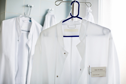 Closeup of doctor's lab coat on hanger in laboratory