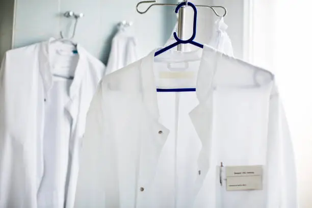 Closeup of doctor's lab coat on hanger in laboratory