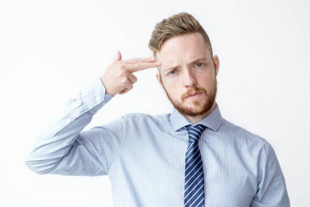 istock Young Business Man Shooting Himself With Fingers 811285392