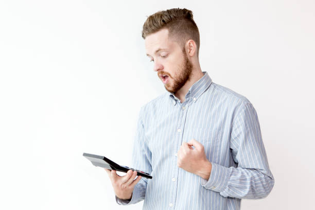 istock Portrait of shocked man looking at calculator 811285512