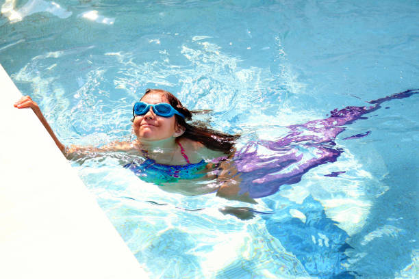 istock Girl with purple mermaid tail 811298800