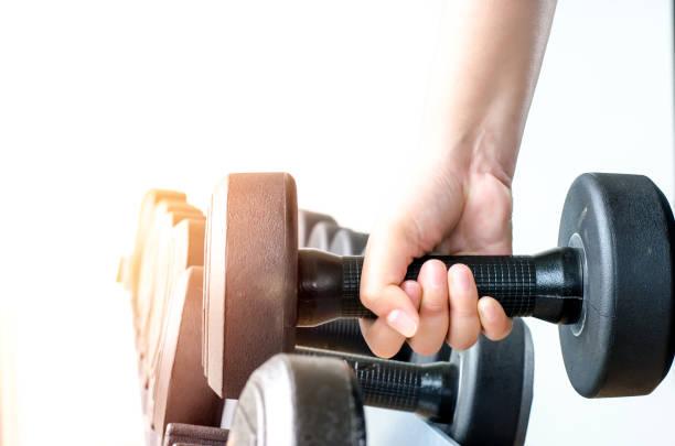 istock strong hand takes a heavy dumbbell in gym 811302844