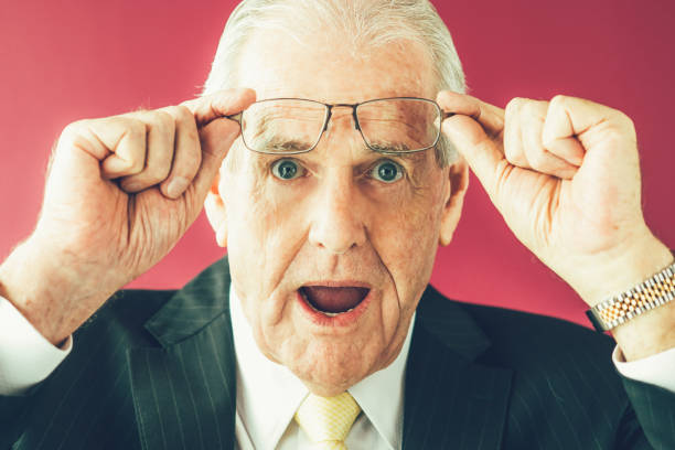 istock Surprised Senior Business Man Raising Glasses 811307892