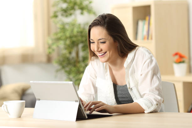 istock Woman writing in a tablet pc at home 811318964