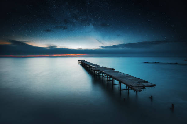 istock Old broken bridge in the sea, long exposure sunrise shot 811319258
