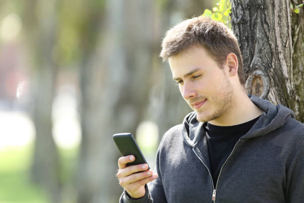 istock Teen boy using a smart phone outdoors 811322476