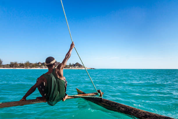 Vezo boatman Vezo boatman on his outrigger canoe in the Ambatomilo lagoon in southwestern Madagascar on october 23, 2016 mozambique channel stock pictures, royalty-free photos & images