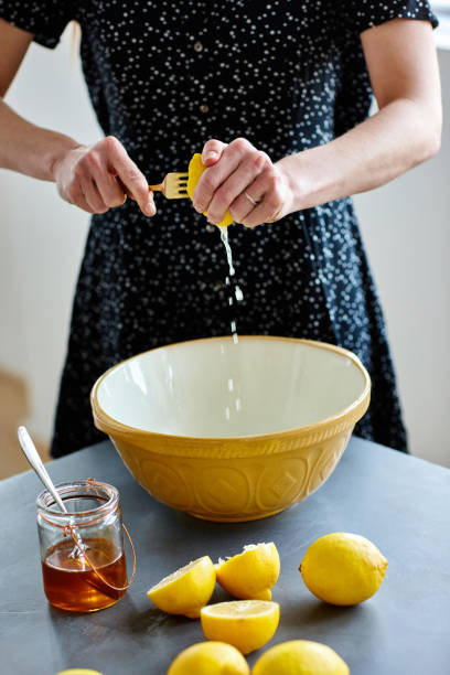 istock Mature woman squeezing lemons in a bowl 811329496