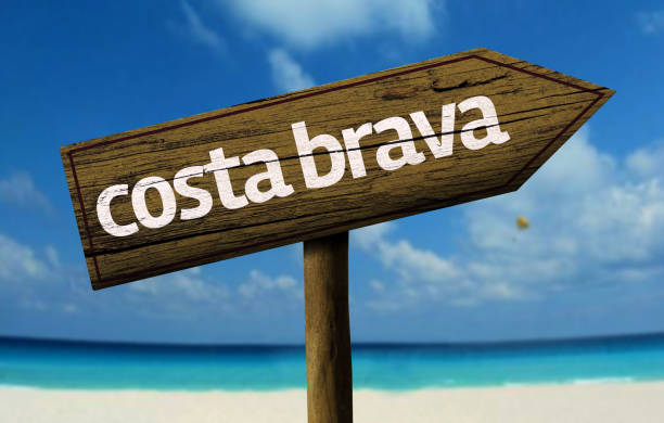 istock Costa Brava wooden sign on the beach 811334052