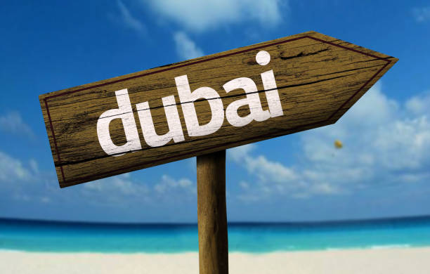 istock Dubai wooden sign on the beach 811334218