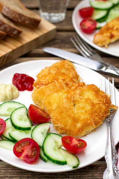 istock chicken nuggets with cheese and bread crumbs with vegetables 811334612