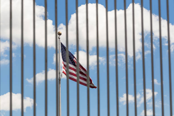 istock The USA flag visible through fence grates 811339040