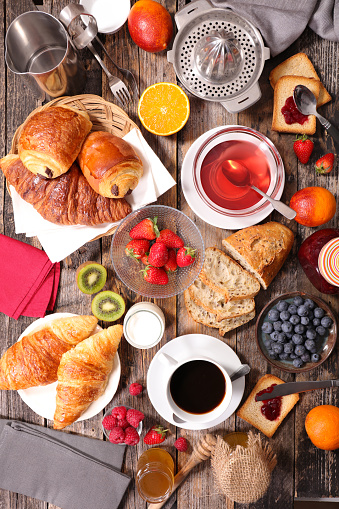 breakfast composition with coffee,tea,croissant and fruits