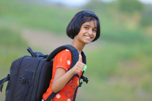 indian girl child with bag - thumps up imagens e fotografias de stock
