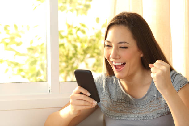 istock Excited woman watching content on smart phone 811355890
