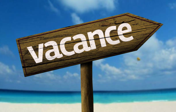 istock Vacation (French: Vacation) wooden sign on the beach 811355998
