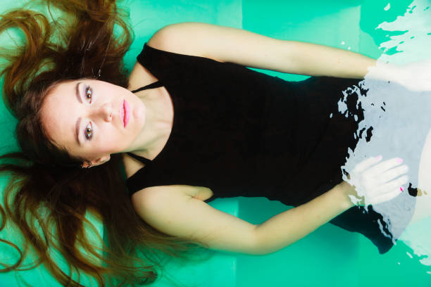 istock Sexual posing woman in water. 811356048