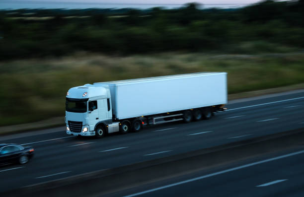 istock Road traffic - white lorry at the dusk time 811360486