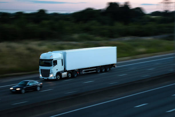 istock Road transport - white lorry at dusk 811360536