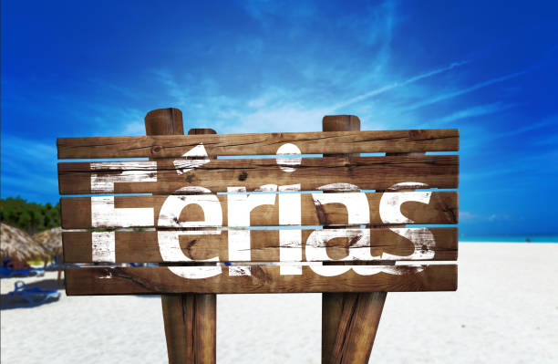 istock Vacation (Portuguese: Férias) wooden sign on the beach 811360598
