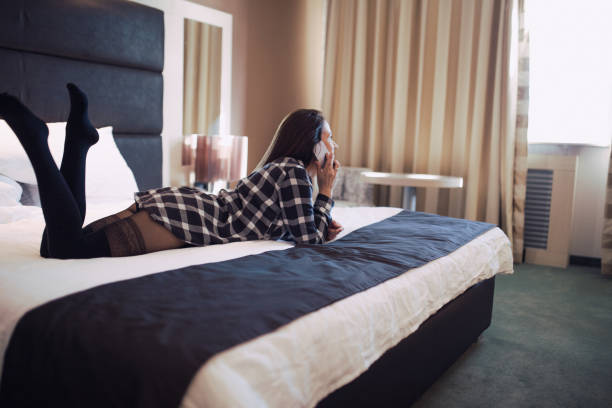 istock Young woman laying in bed using phone 811360976
