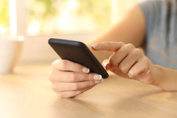 istock Woman hand selecting content on a smart phone 811361102