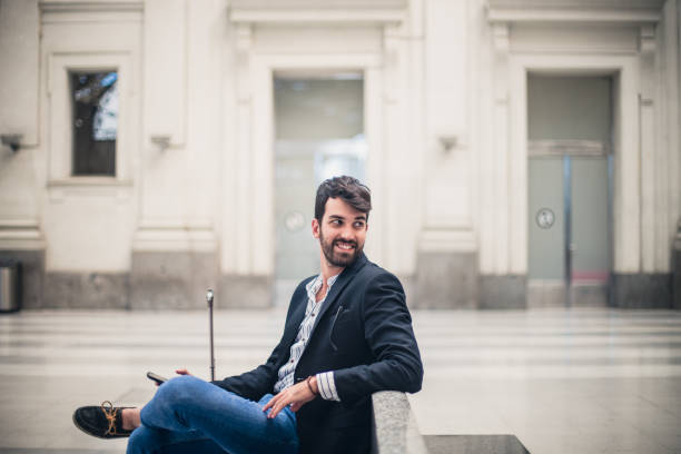 istock Hipster man waitining on a railroad station 811367462