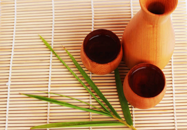 istock SAKE liqueur in a brown wooden bottle on a light brown background. 811377668