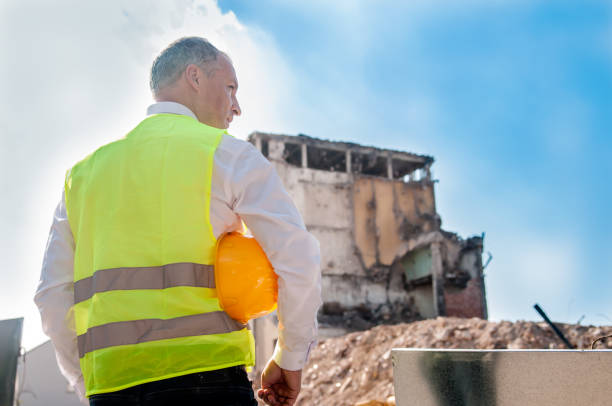 istock Male contractor or civil engineer looking at the building project on progress 811388958