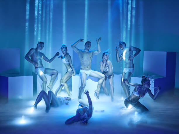 The group of modern ballet dancers The group of modern ballet dancers on blue studio background dance troupe stock pictures, royalty-free photos & images